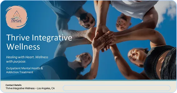 A group of people putting their hands together.